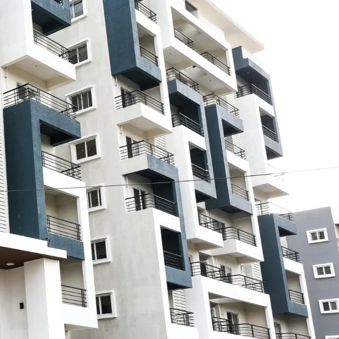 A tower corner with balconies above a planted boundary wall at HPR Lakefront