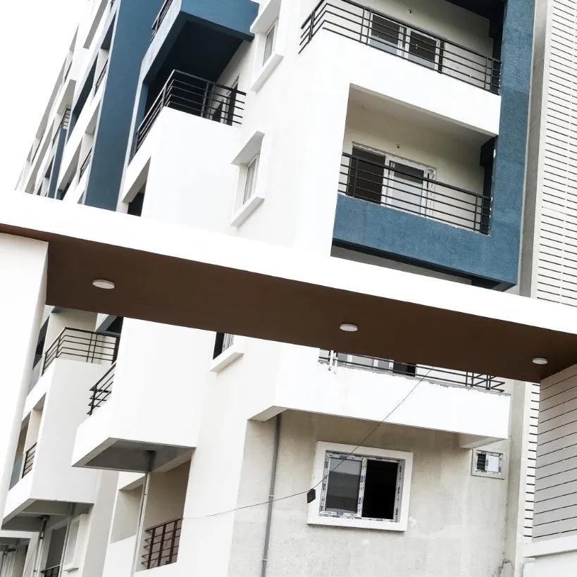 Tiers of balconies with slate-grey frames rising over the entrance at HPR Lakefront